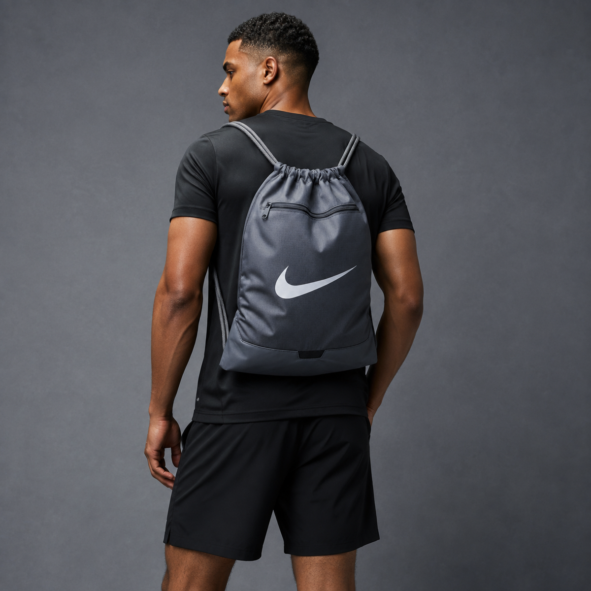 Athletic model wearing the grey FCTR Apparel Nike Drawstring Bag